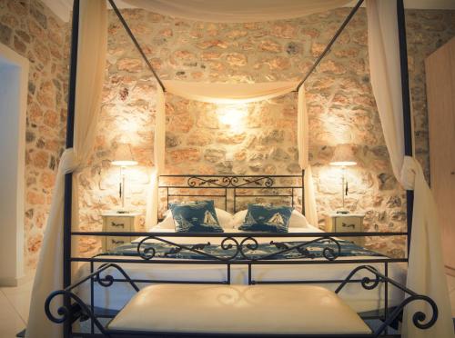 a bedroom with a bed with a wrought iron bed frame at Paradiso in Hydra