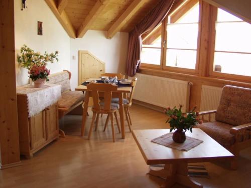 a living room with a table and a couch and a table at Ferienwohnungen Bergblick in Immenstadt im Allgäu