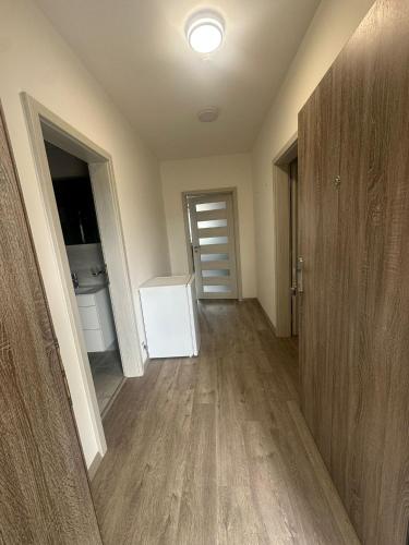 an empty room with a door and a hallway at Penzion Kurtovka Staňkovice in Staňkovice