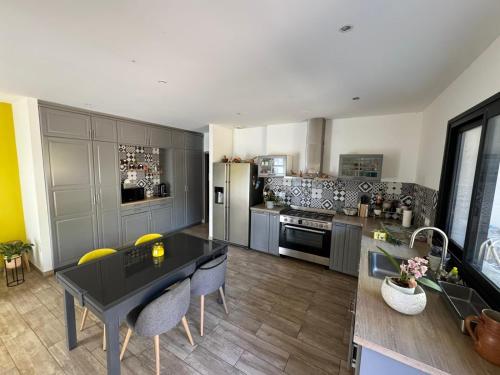 a kitchen with a table and chairs and a refrigerator at Charmant appartement Port & Plages ! in Bandol