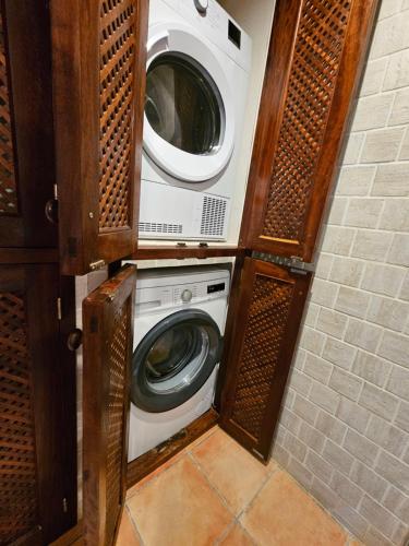a washer and dryer in a small room at Villa en Sa Caleta - CAN BLAU IBIZA in Ibiza Town