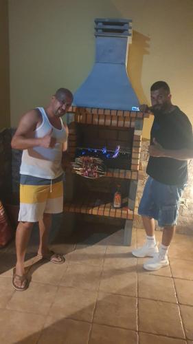 two men standing in front of a fireplace at Grande Maison Rurale in Tuineje