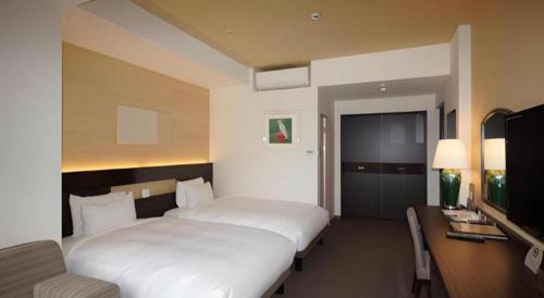 Hotel Riverge Akebonoにあるベッド