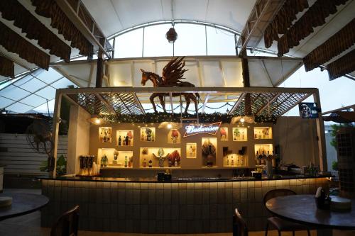 a display case in a restaurant with a horse statue at Hotel Sadanand Regency - Newly Renovated in Pune