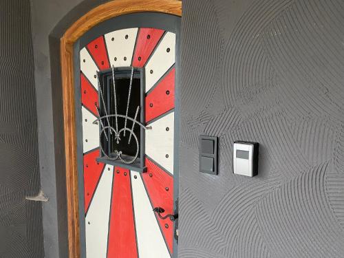 a door with a mirror on a wall at s`gmiatli in Iselsberg