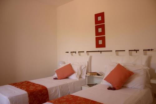 a room with two beds and a sign on the wall at Guest House - La Sirena Salentina in Patù