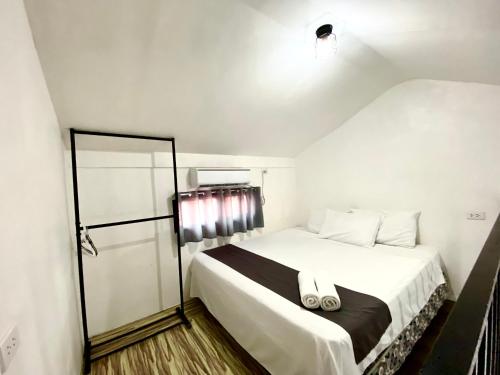 a bedroom with a large white bed in a room at JNJ Apartelle in Tacurong