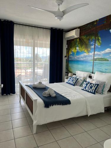 a bedroom with a large bed with a view of the ocean at Ti Paradis 1 in Les Trois-Îlets