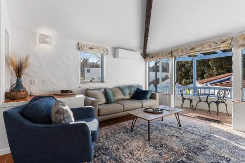 a living room with a couch and a table at Sea Breeze - Orewa Oceanside Apartments in Orewa