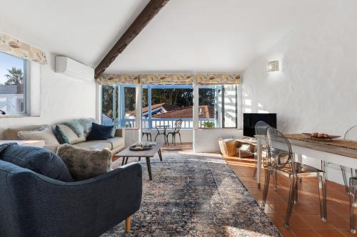 a living room with a couch and a table at Sea Breeze - Orewa Oceanside Apartments in Orewa