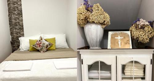 a bedroom with a bed and a vase with flowers at Apartment Abba in Međugorje