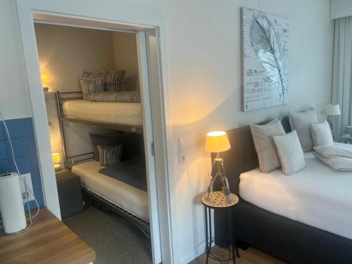 a bedroom with two bunk beds and a mirror at Haus Grünewald Unsleben in Unsleben
