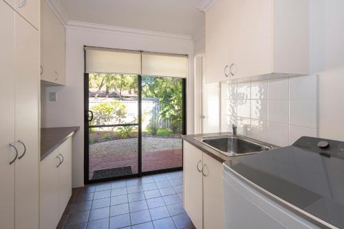 a kitchen with a sink and a large window at Little Herring Ducted AC heating, Secure yard in Vasse