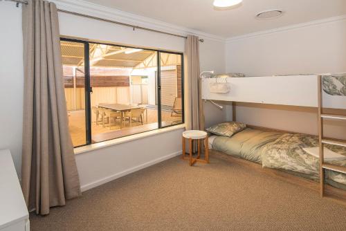 a bedroom with a bunk bed and a table at Little Herring Ducted AC heating, Secure yard in Vasse