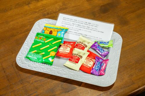 a plate topped with different types of candy on a table at 大和の宿 Kitakyobate in Nara