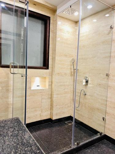 a bathroom with a shower with a glass door at Casa Kasauli in Kasauli