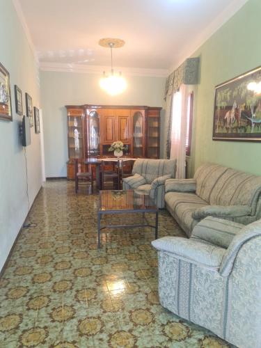 a living room with two couches and a table at Casa Verde in Taviano