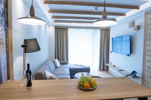 a living room with a couch and a table at BiancaNeve Jahorina in Jahorina