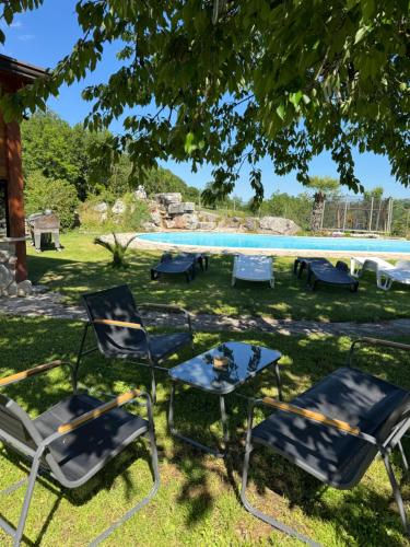two chairs and a table in front of a pool at Villa Aresini in Montemiletto