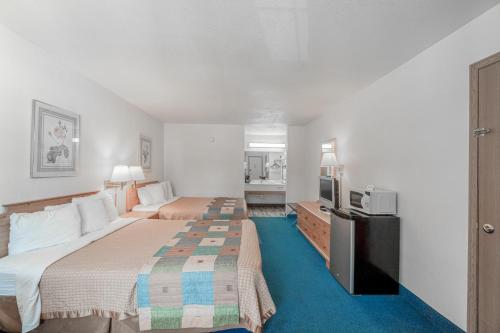 Ένα ή περισσότερα κρεβάτια σε δωμάτιο στο Hotel O Eureka Springs - Christ of Ozark Area