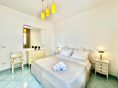 a bedroom with a bed with two towels on it at Casa Appia, fronte mare con giardino - Marea Stays Collection in Nardò