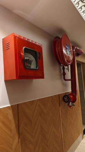 a red fire hydrant on a wall in a room at Hotel Kashi Crown in Varanasi