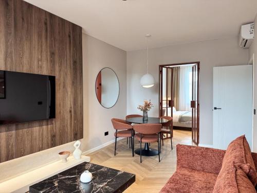 a living room with a couch and a table at Premium Art Deco Loft in Iaşi