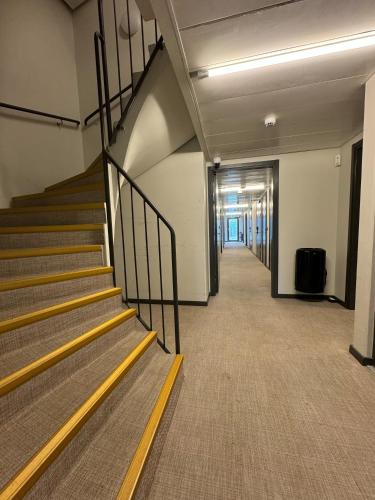 an empty hallway with stairs in an office building at Injoy Classic Hotel Elmia in Jönköping