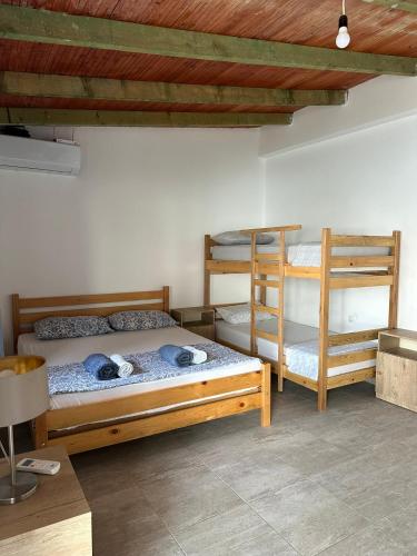 a bedroom with two bunk beds and a desk at Villa Kate in Borsh