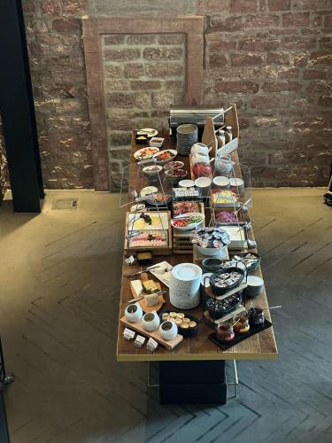 a table with a bunch of different types of desserts at Hotel Liberty Offenburg in Offenburg