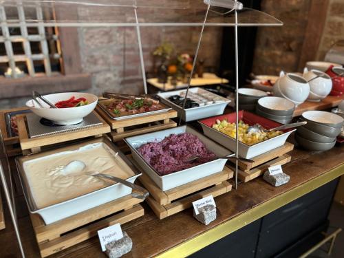 a buffet line with many different types of food at Hotel Liberty Offenburg in Offenburg