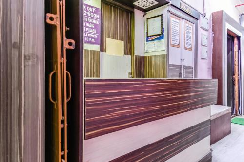 a front door of a restaurant with a wooden gate at Hotel O A One Guest House in Kolkata