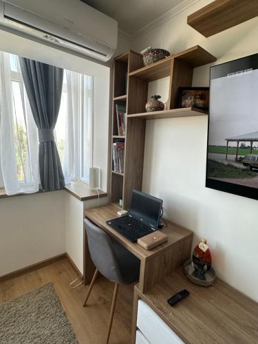 a room with a desk with a laptop on it at Central apartment in Carei