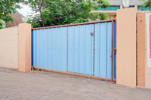 a blue fence in front of a building at SPOT ON Hotel Dezire Dhankot Chowk in Gurgaon