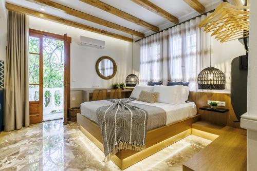 a bedroom with a bed and a large window at Villa Apostolis Studios in Skopelos Town