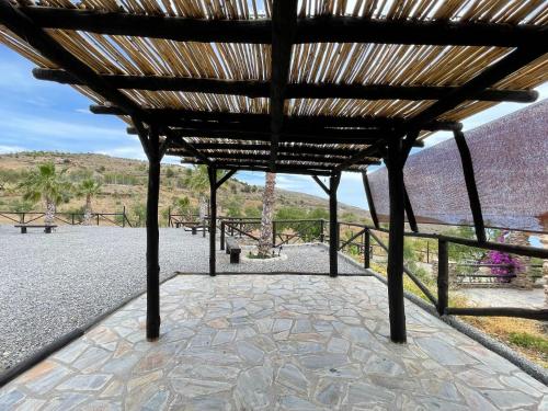a wooden pavilion with a view of the desert at Casa Crisantemo with sea view and pool in Adra in Las Hoyas del Barranco