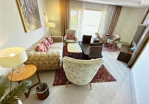 a living room with a couch and a table with two laptops at Tolip Resort El Galala Heights in Ain Sokhna