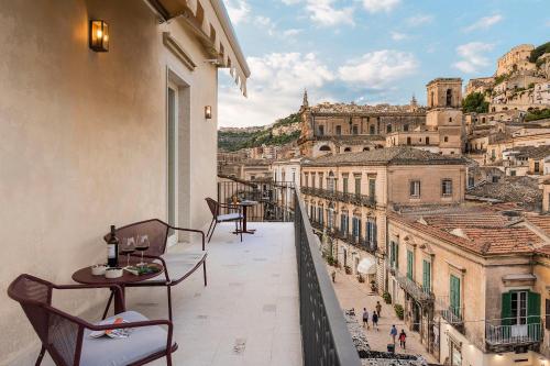 a balcony with chairs and a view of the city at Al Monumento in Modica