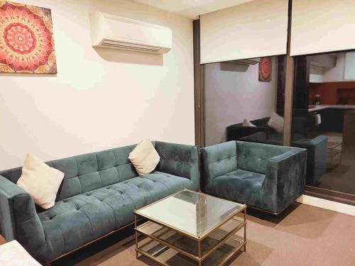 a living room with a couch and a coffee table at 3 Bedroom Apartment Opposite Melbourne Central in Melbourne