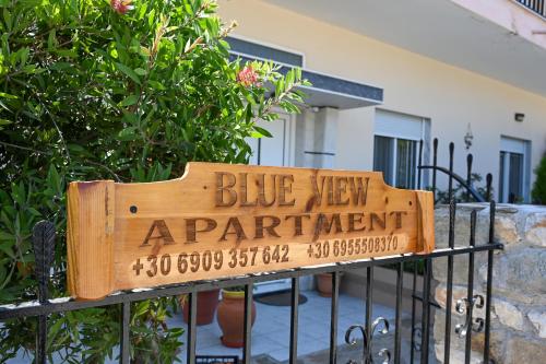 a blue view apartment sign on a fence at Blue View in Kavala