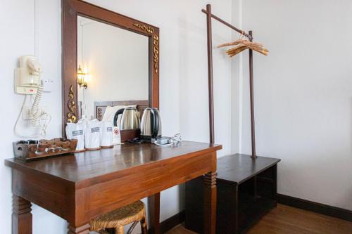 a dressing table with a mirror on a wall at SK Boutique Mahanakhon in Bangkok
