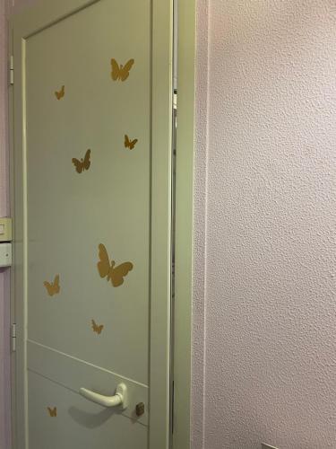 a cabinet with butterflies on it next to a wall at Appartamento nel cuore di Todi in Todi