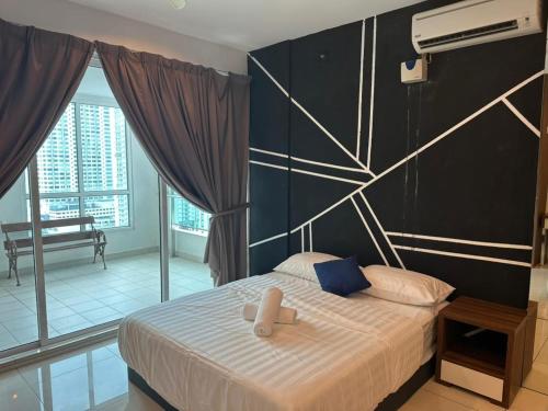 a bedroom with a bed and a large window at Mansion One Seaview Studio 4 pax Gurney in George Town