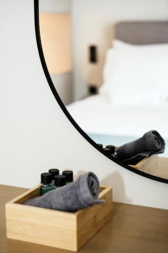 a mirror on top of a wooden box with a camera at Vardians Villas & Suites in Karistos