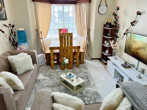 a living room with a couch and a table at Casa Solenda in Ruaka