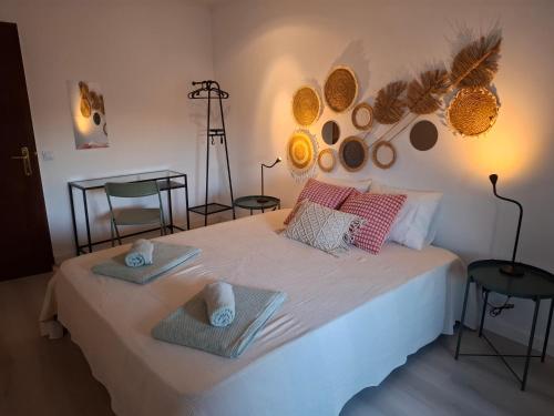 a bedroom with a bed with two towels on it at Olhão 1st floor apartment in Olhão
