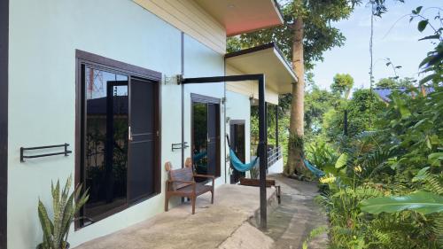 a room with a hammock on the side of a house at Sleep Inn - Lonely Beach in Ko Chang
