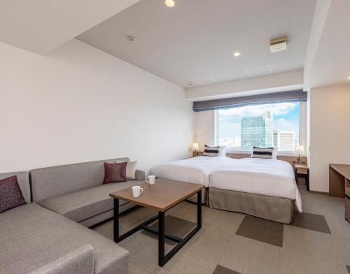 a hotel room with a bed and a couch at Tokyu Stay Aoyama Premier in Tokyo