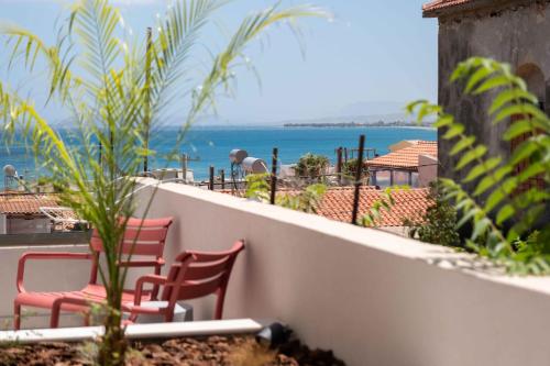 a balcony with chairs and a view of the ocean at See2sea Cozy Apartments in Kolymvari