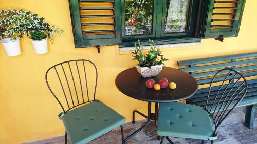 a table with two chairs and a table with fruit on it at Douro Valley - Casa Vale do Douro in Lamego